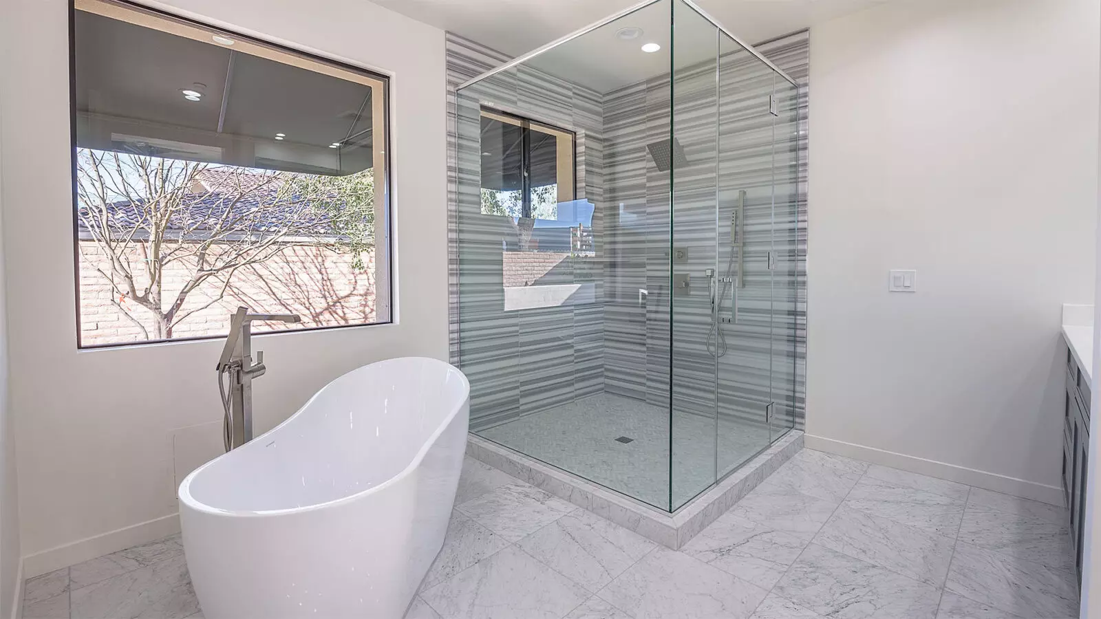 A Phoenix Contemporary designed bathroom with a shower and tub
