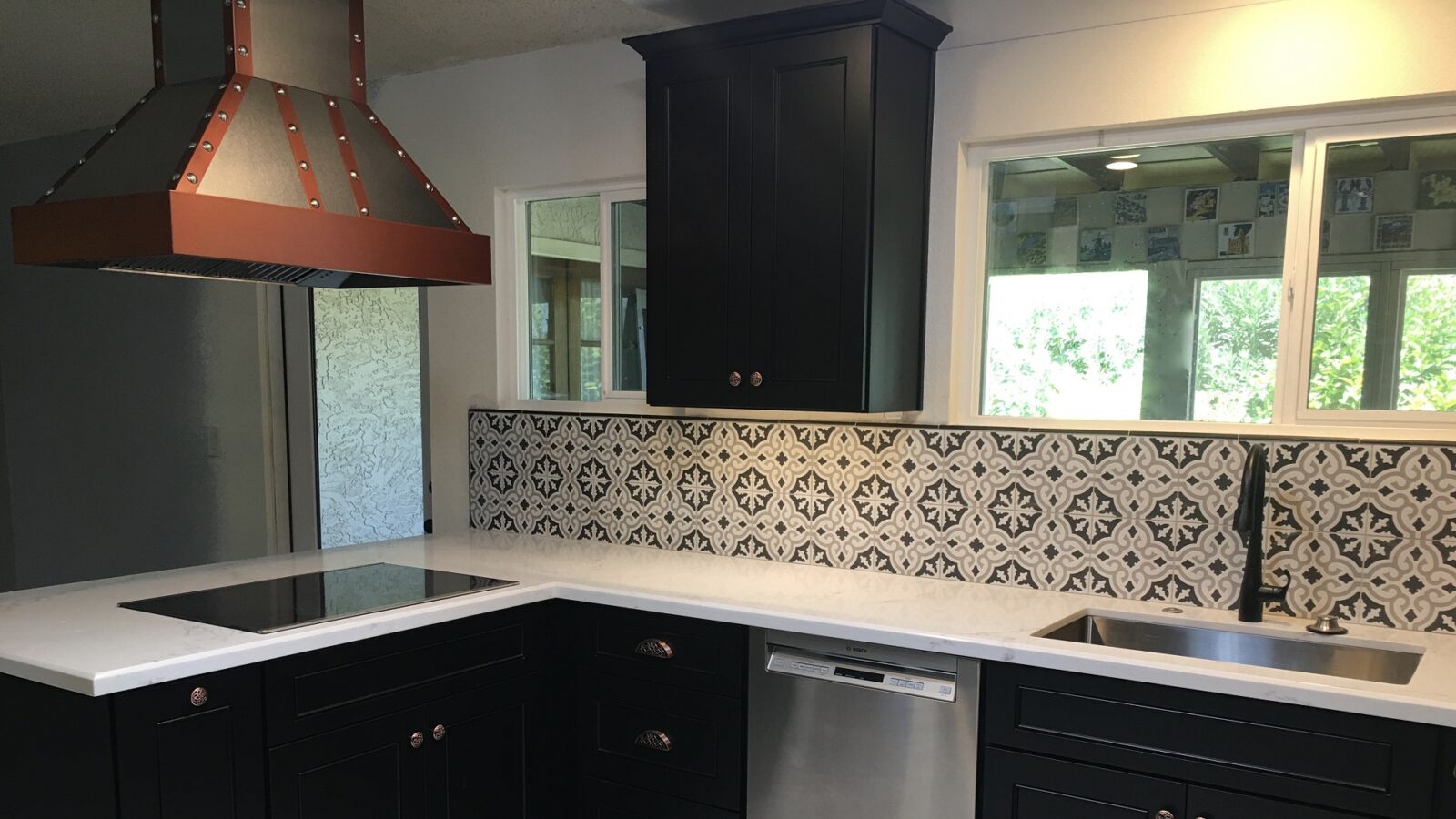 A white kitchen counter top with black cabinets