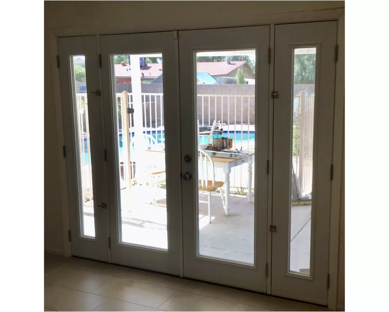A picture of large doors overlooking the pool
